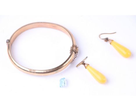 A pair of yellow metal mounted amber drop earrings; together with a rolled gold bangle and a loose blue topaz stone.Condition