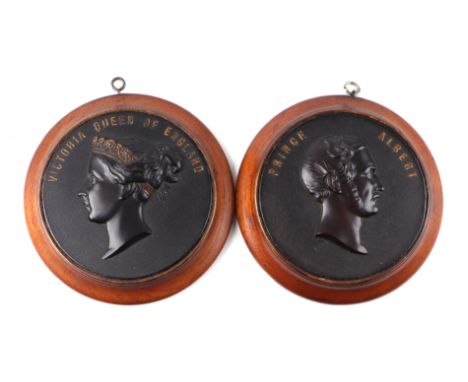 A pair of Victorian Bois Durci portrait plaques depicting Queen Victoria and Prince Albert, circa 1860, attributed to Francoi