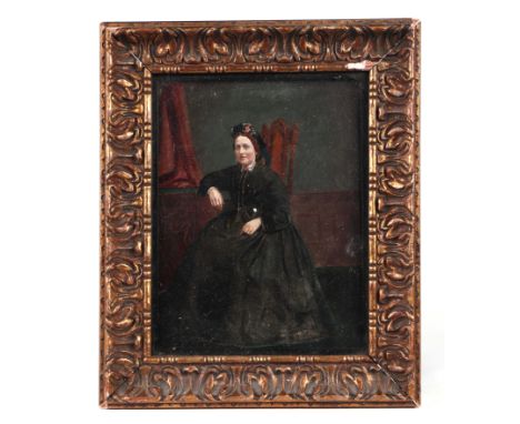 A Victorian overpainted print depicting a lady in mourning dress, 17 by 21cms, framed & glazed.