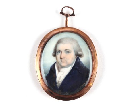 An 18th/19th century yellow metal mounted oval portrait miniature on ivory depicting a gentleman wearing a wig and a blue coa