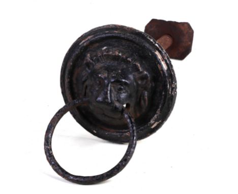 A large 19th century cast iron lion and mask door knocker or horse tether, 15cm diameter  