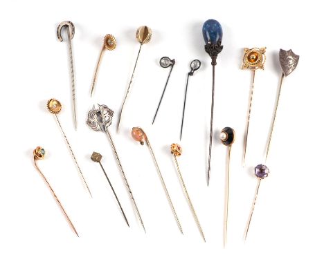 A group of stick pins to include one of 15ct, yellow metal and white metal.