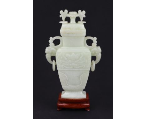 A Chinese pale jade vase and cover of flattened baluster form with flower finial on hardwood stand, in original box. 18.5cm h