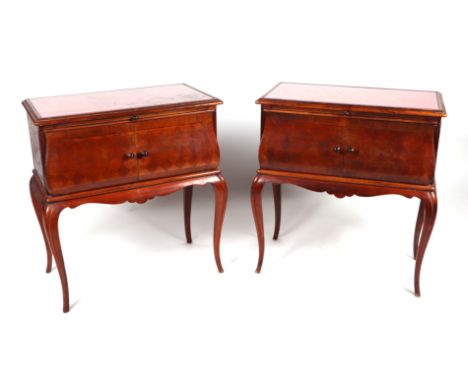 A pair of French bedside cabinets, possibly fruitwood, the rectangular top above a brushing slide with cupboards below enclos