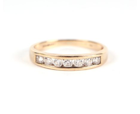 A 9ct gold ring set with seven white stones, approx UK size 'K', 1.7g.