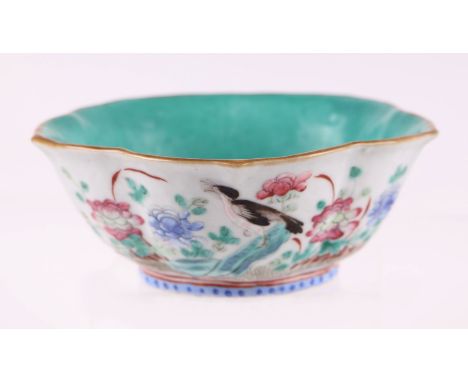 A Chinese Qing dynasty famille rose lotus flower bowl decorated with birds and flowers, red seal mark to the underside, 14cms