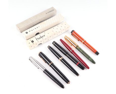 A group of Parker fountain pens together with other pens and three parker pen boxes