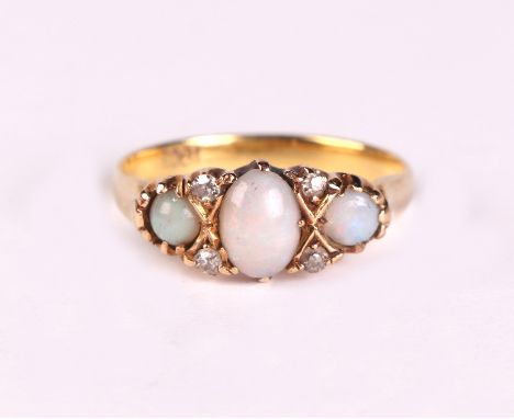 An 18ct gold ring set with three opals interspersed with diamonds, approx UK size 'M', 3.4g.