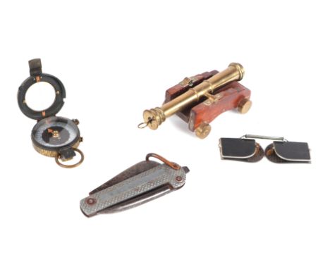 A desk top cannon, 15cms long; together with a WWI marching compass; a pocket knife and a pair of goggles (4).Condition Repor