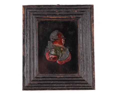 A late 18th / early 19th century hand coloured wax profile portrait of Benjamin Franklin, 7 by 9cms, framed & glazed.