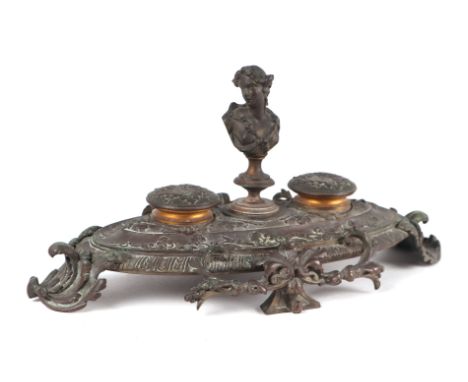 A 19th century French brass double inkwell with the bust of a lady to the centre, 32cms wide.