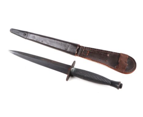 A Fairbairn- Sykes Commando fighting knife, Cross guard stamped with maker William Rodgers. 32cms long, with leather scabbard