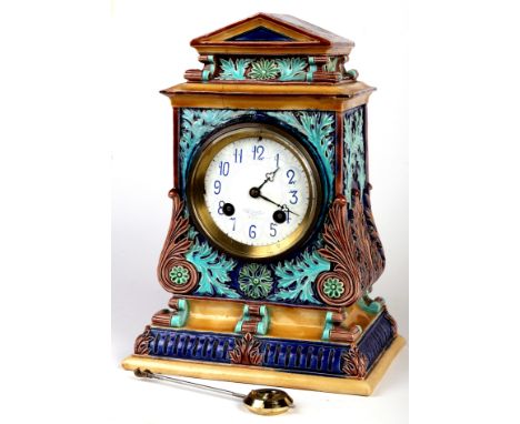 A Doulton Lambeth Stoneware mantel clock of architectural form in the manner of George Tinworth, the white enamel dial with a