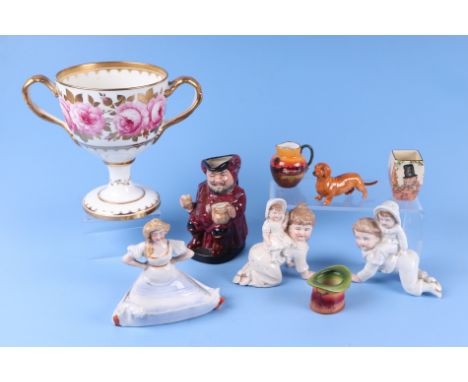 A Cauldon twin handled pedestal cup decorated roses, 17.5cm high; a Royal Doulton character mug, Falstaff; a risque pin dish 