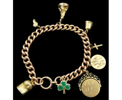 9ct rose gold curb link bracelet, with spring loaded barrel clasp and seven 9ct gold charms including green enamel shamrock, 