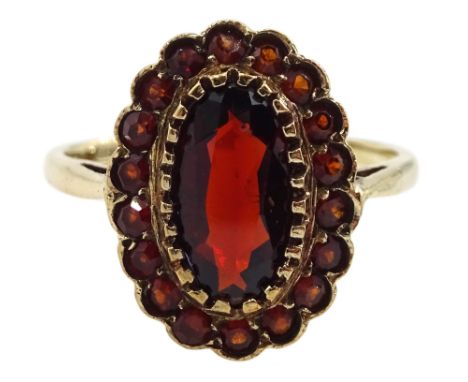 9ct gold oval and round garnet cluster ring, hallmarked Condition Report:Approx 2.9gm, size M-N, head diameter 15mm x 12mm, c