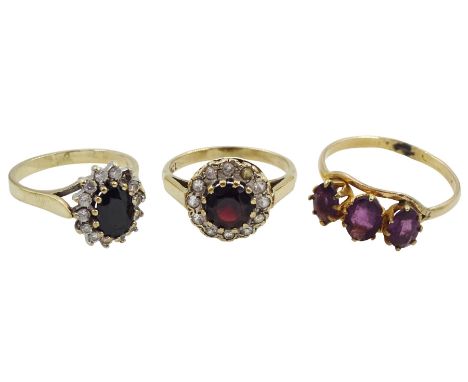 Gold three stone amethyst ring, gold garnet and cubic zirconia cluster ring and one other gold stone set ringCondition Report