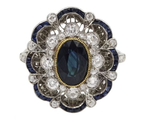 Platinum oval cut sapphire and old cut diamond cluster ring, in an openwork setting with calibre cut sapphire and diamond set