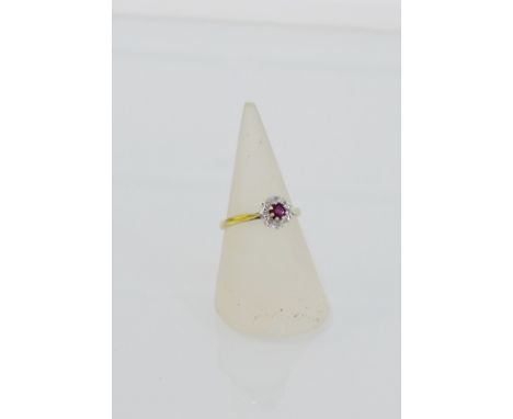 A 9 carat gold ruby and diamond set dress ring, UK ring size Q