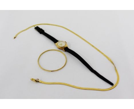 A 14 carat gold chain necklace stamped Italy 14k together with a child's unmarked yellow metal bangle and a gold plated Oris 