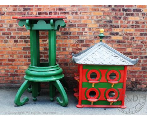 A large modern Chinese style green and red painted dovecote, with lead lined roof above sixteen apertures, on green stand wit