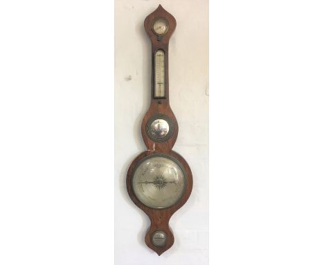 A late George III rosewood wheel barometer, with silvered dial, thermometer and concave mirror Provenance: Clynog Farmhouse, 