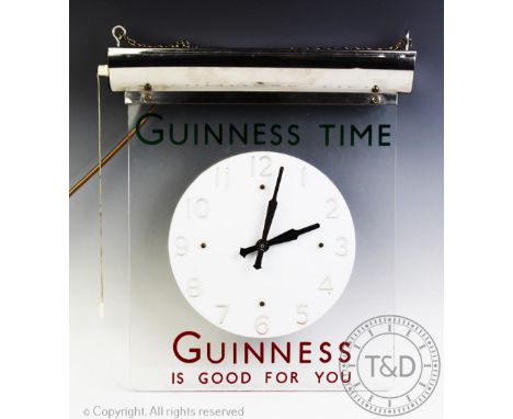 A Guinness advertising clock circa 1950s, in acrylic with chrome lamp holder, chain-suspended and baring the legends “Guinnes