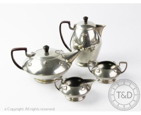 A Warric four piece Arts &amp; Crafts pewter tea service, comprising: a teapot and cover of compressed form,10.5cm high, a ho