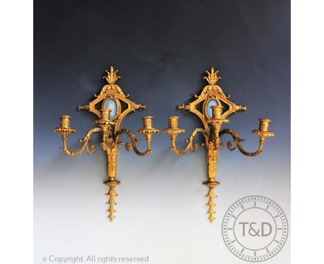 A pair of George III style gilt metal three branch wall lights, each set of a Wedgwood type blue Jasper plaque, 52cm (one at 