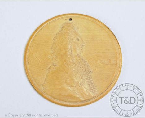 A late 17th / early 18th century ivory profile portrait relief attributed to Jean Cavalier, the tondo plaque carved with a si
