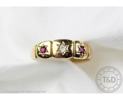 A Victorian ruby and diamond 18ct gold ring, engraved '1884', the central diamond flanked by two untested rubies to either si