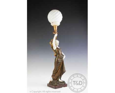 A bronzed spelter and composition figural table lamp, modelled as a maiden, with opaque glass globe shade, on cast plinth and