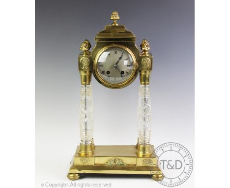 An early 20th century Hamburg American Clock Company portico clock with key and pendulum, the clock mounted in a brass case w