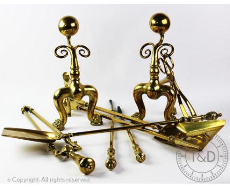 A pair of Victorian brass fire dogs, with ball finals and scroll detailing, on paw feet, 34cm H, with sets of three Victorian