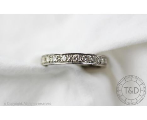 A diamond set full eternity ring, set throughout with brilliant cut diamonds and all set in white metal, unmarked, size O, we