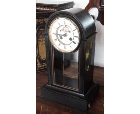 A 19th century eight day slate mantel clock, with Roman numeral chapter ring (cracked) and visible escapement, with movement 