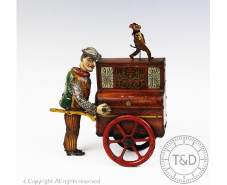A vintage tin plate music box in the form of an organ grinder, his cart and a dancing monkey, 19.5cm high (at fault)