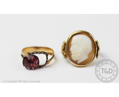 A cameo set ring, the oval shell cameo depicting a bearded man in profile, within rub-over setting, to the split shoulders an