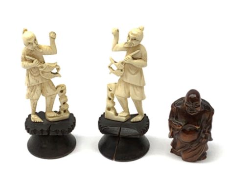 Two carved bone figures, each modelled as a fisherman with catch, overall H9cm, together with a Japanese wooden Netsuke model