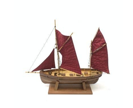 A wooden model of a twin masted fishing yawl, on stand, L60cm.  - Condition Report 