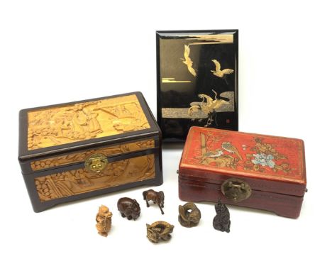 A group of six carved wooden netsukes, modelled in various forms, to include dragons, a horse, and a elephant with inset moth