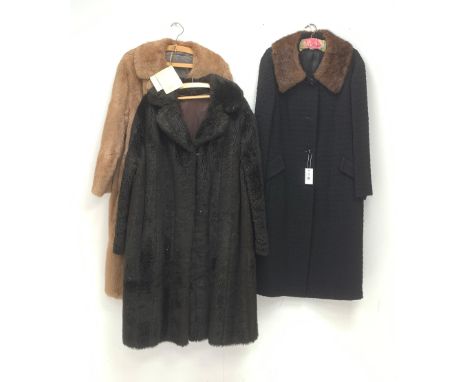 A Ladies light brown Musquash fur coat, together with a faux fur example, and another coat with fur collar.  - Condition Repo