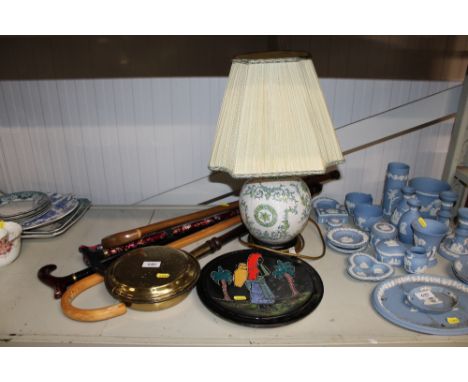 A brass warming pan; two pottery plates; a table lamp and shade together with a quantity of walking sticks