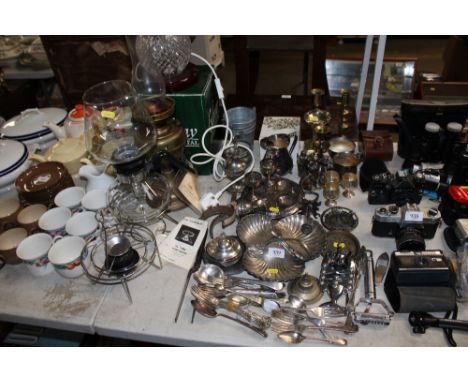 A quantity of metal ware; a brass oil lamp; a spirit heater etc.