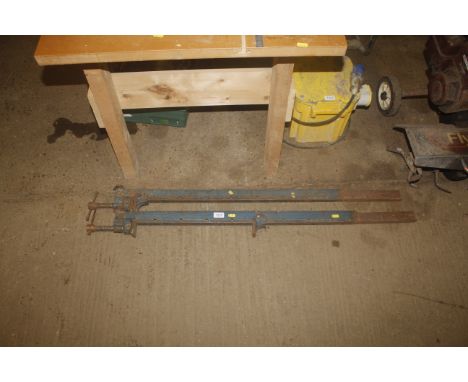 A pair of metal sash clamps 
