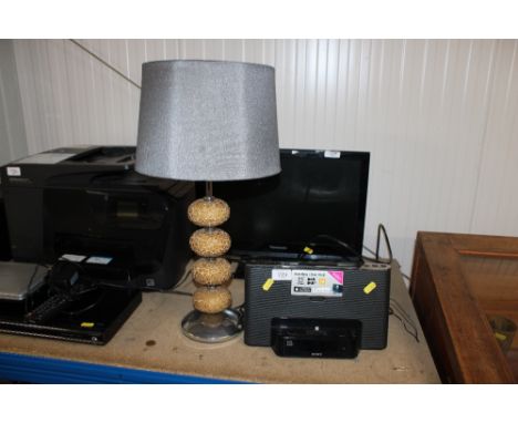 A Sony docking station and a table lamp