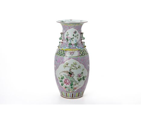 A FAMILLE ROSE TWIN HANDLED PORCELAIN VASE
With foo dog handles and chilong to the neck, a shaped reserve with a bird perched