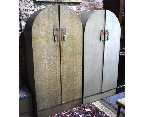 An Art Deco period child's bedroom set comprising two dome top twin door wardrobes, the interiors with hanging space and stor