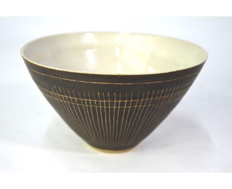 Lucie Rie, a brown glazed porcelaneous stoneware bowl, the inner with white tin glaze, the outer with scraffito decoration, t