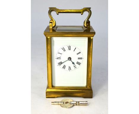 A lacquered brass 8-day carriage clock, the white enamelled dial with roman numerals, 12 cm h&nbsp;